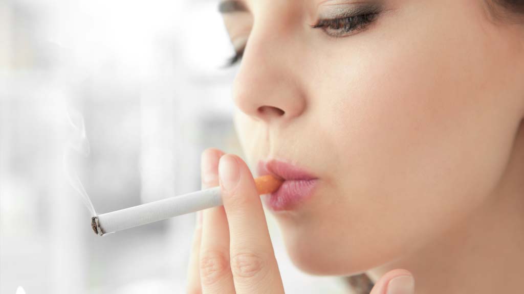 woman smoking cigarette before getting laser therapy to stop smoking