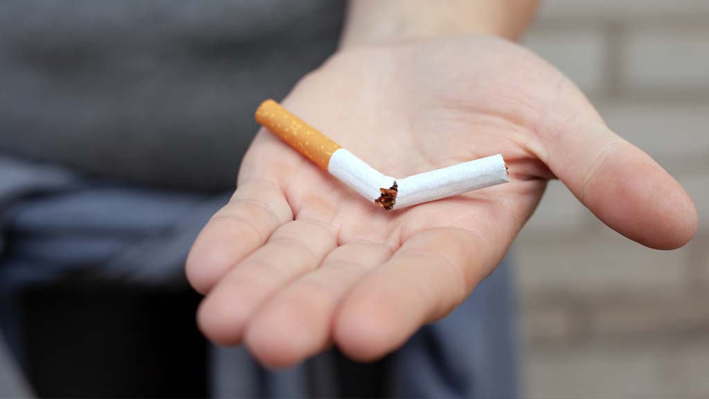 close up of a hand holding a broken cigarette after laser therapy to quit smoking in stamford ct