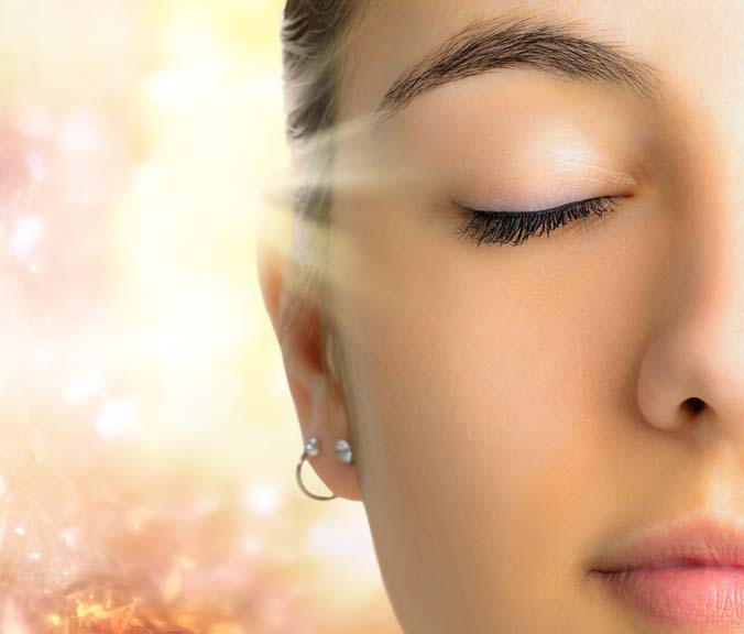 woman with eyes closed warm sunlight after detoxification treatment