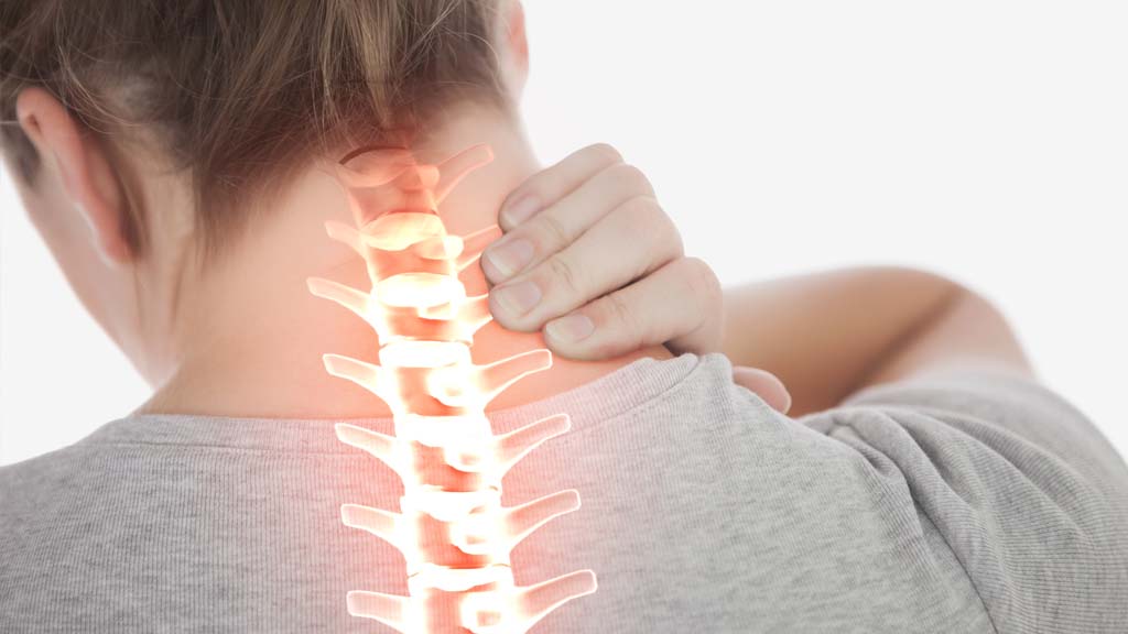woman has hand on neck pain in stamford, ct that radiates from spine