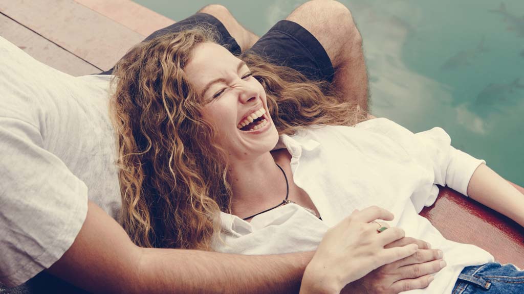 woman relaxing and laughing after pain relief treatment